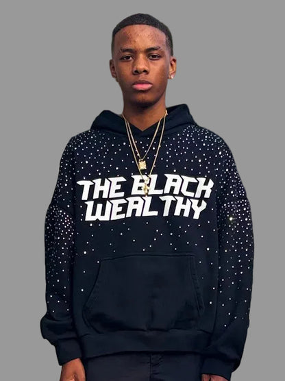 Person wearing a black hoodie with 'THE BLACK WEALTHY' text.
